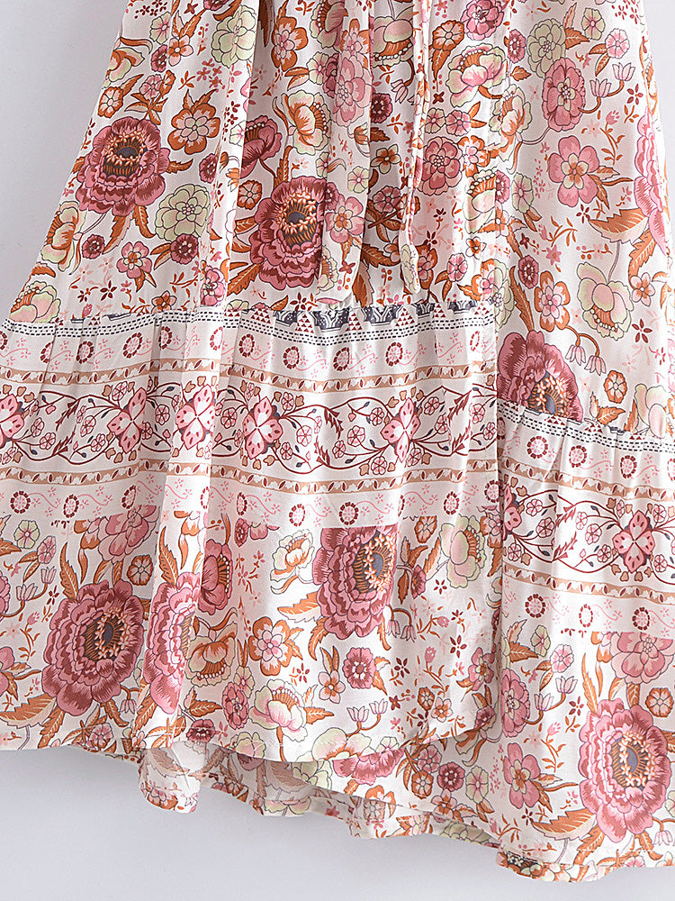 Floral patterned fabric with pink and orange flowers on a white background