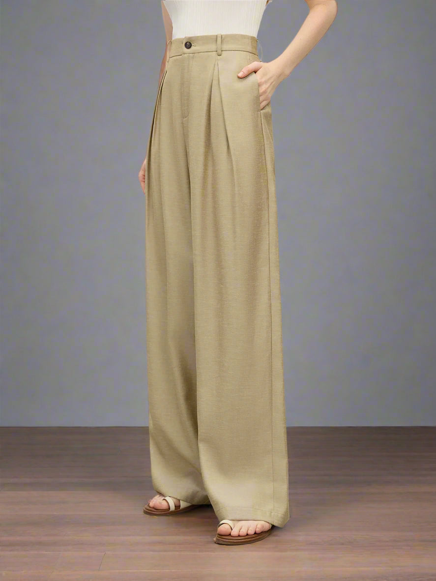 Beige wide-leg pants worn by a person on a plain background