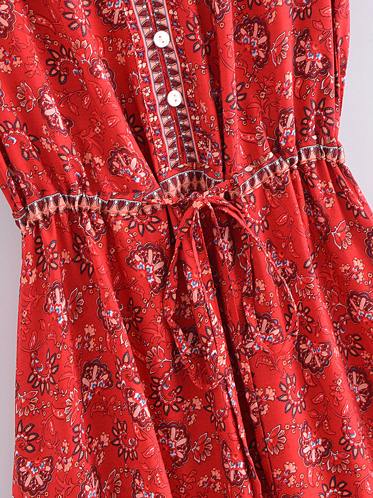 Red patterned dress with buttons on a plain background