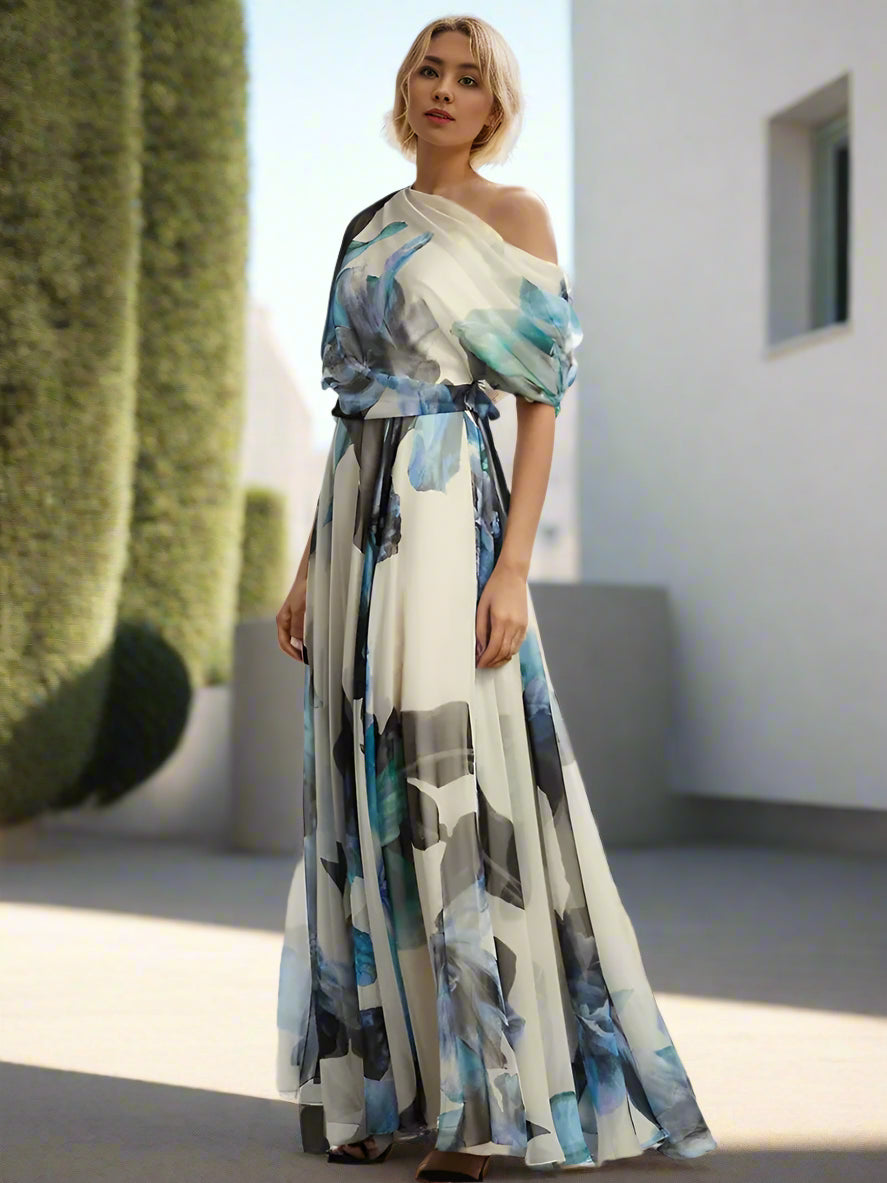 Woman in a colorful dress standing on a city street with tall buildings in the background