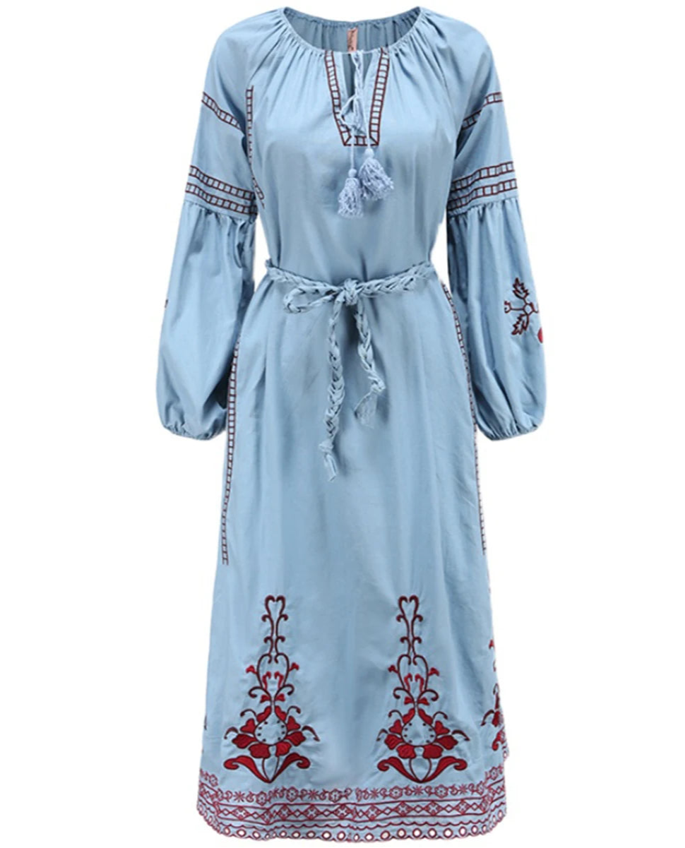 Light blue dress with red and white embroidery on a white background