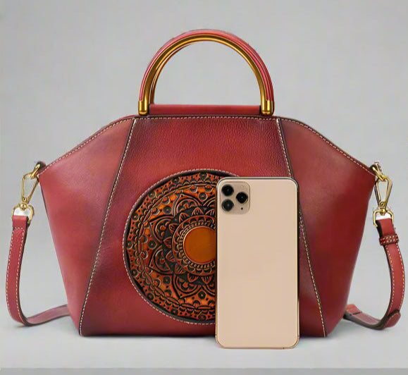 Red handbag with decorative elements, phone, on a white background