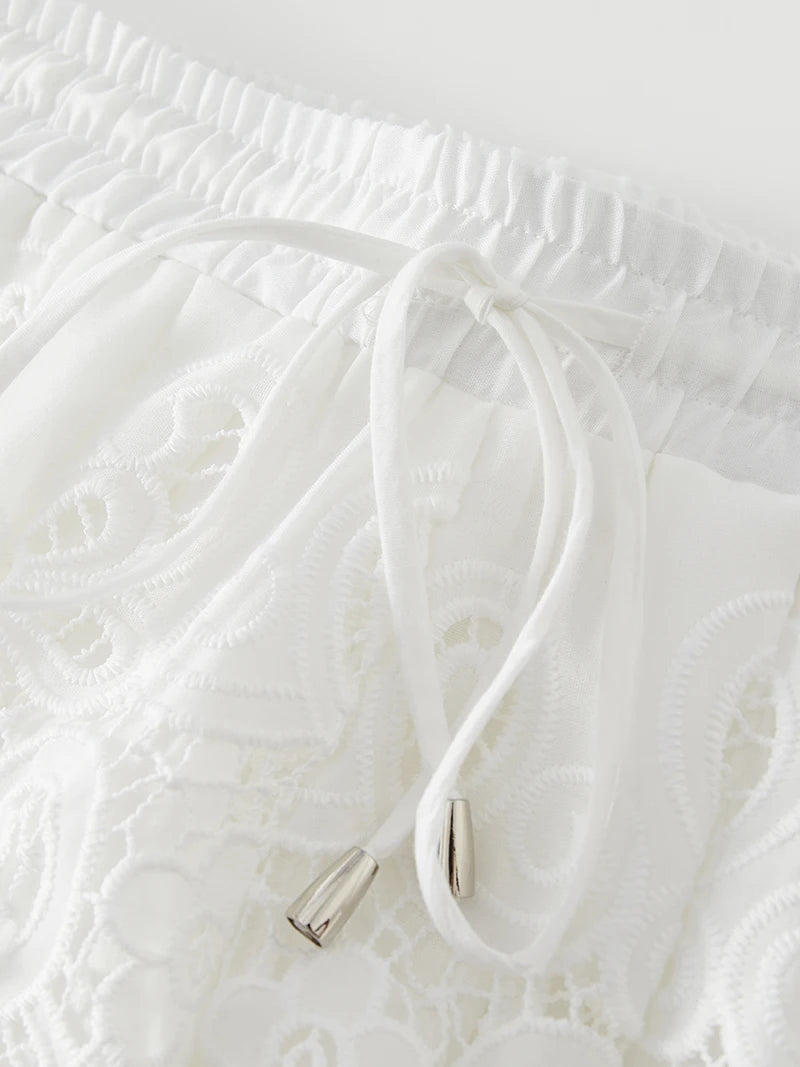 White cable with metallic connector on a textured white background