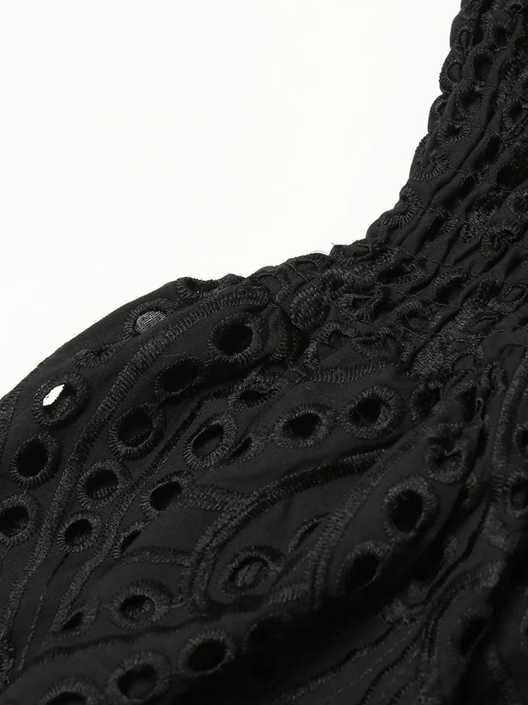 Close-up of black textured fabric with a white background