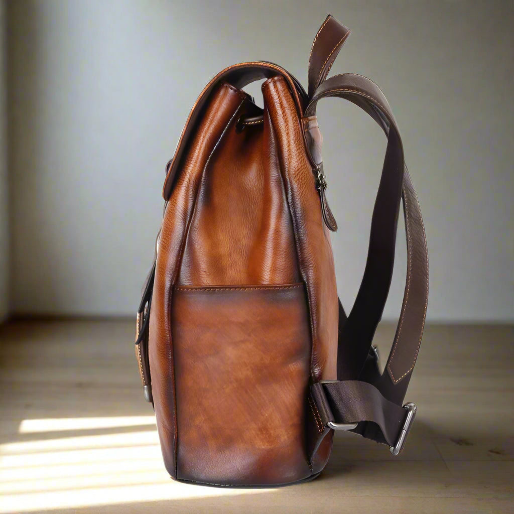 Brown leather backpack on a white background