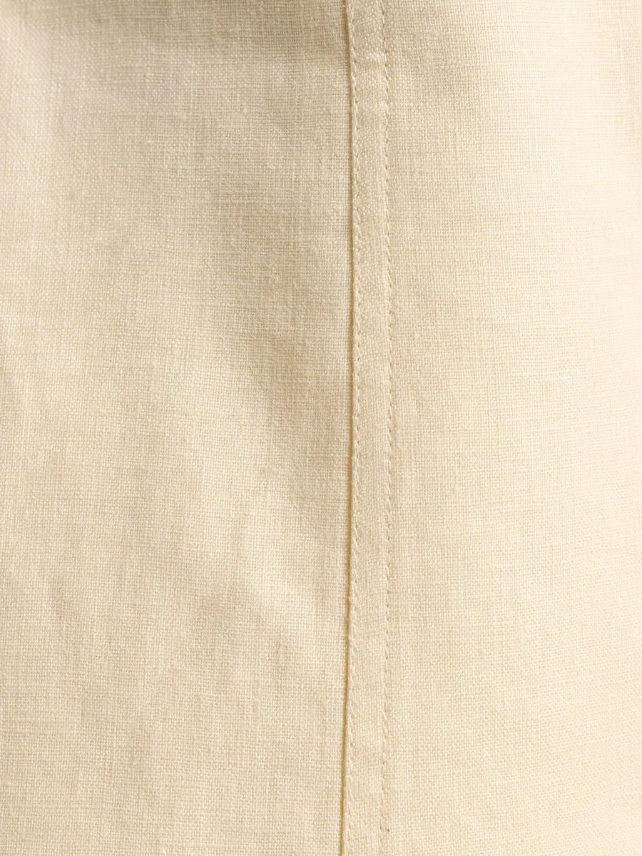 Close-up of beige fabric with a seam