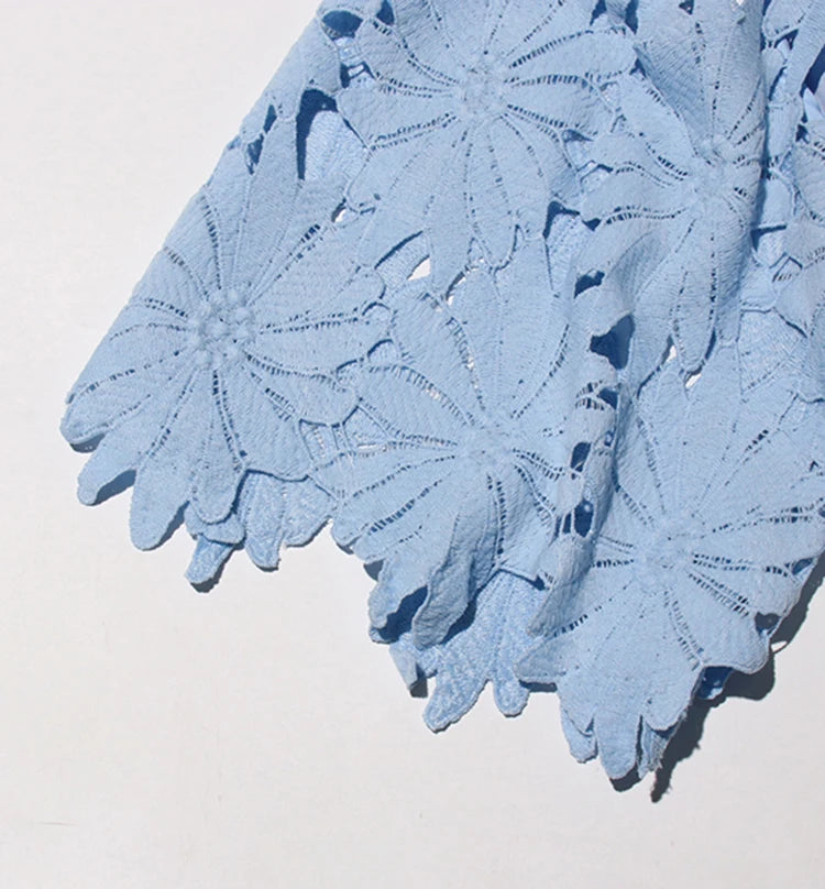 Light blue lace fabric on a white background