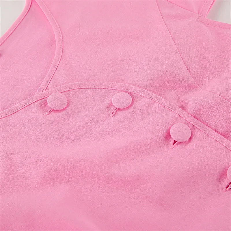 Close-up of a pink sleeveless top with button details on a light gray background