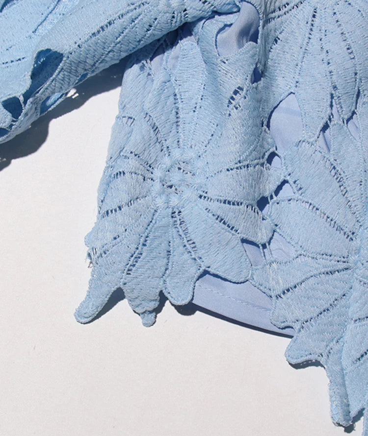 Light blue lace fabric on a white background