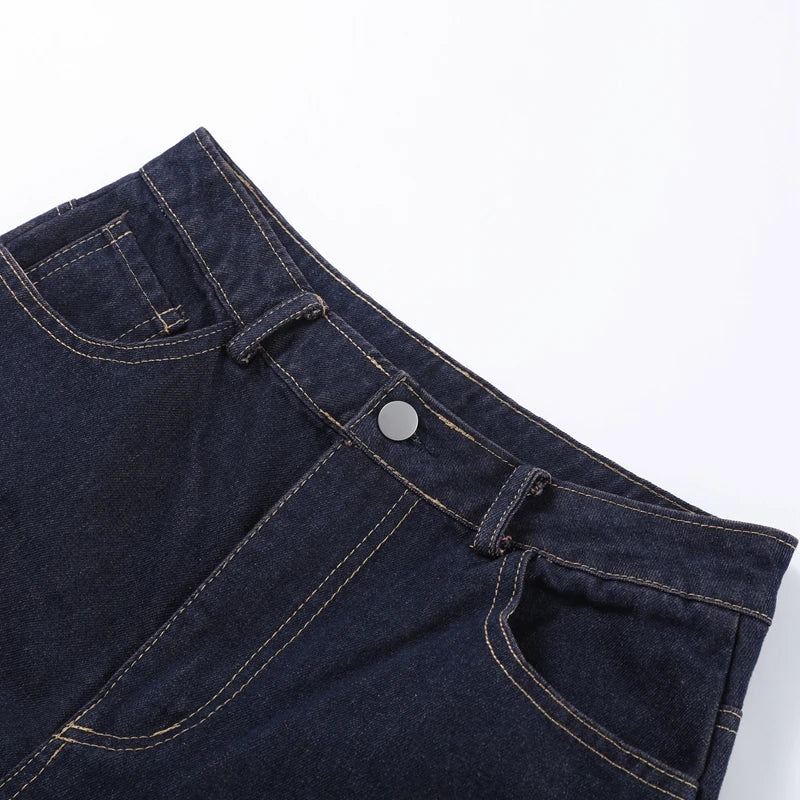 Close-up of dark blue denim jeans on a white background