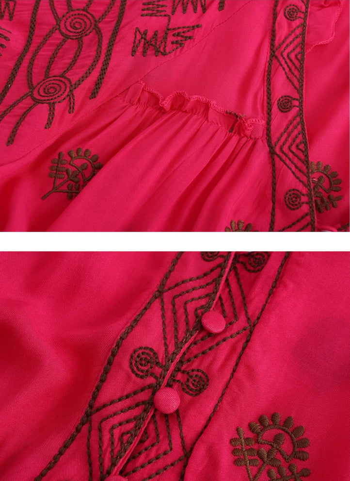 Red garment with black embroidery on a white background