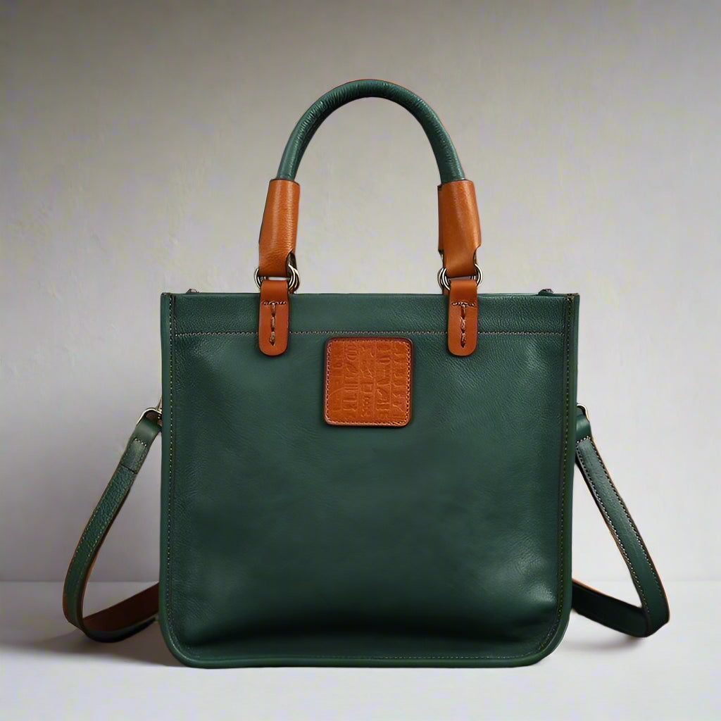 Green handbag with brown handles and accents on a white background
