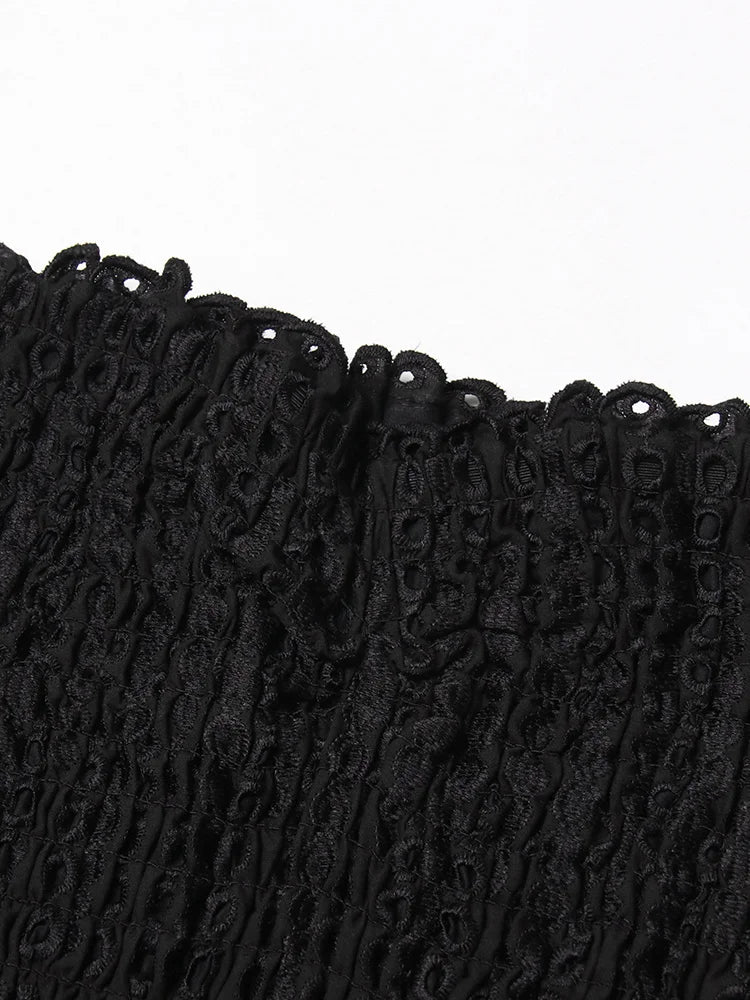Close-up of black lace trim on a white background