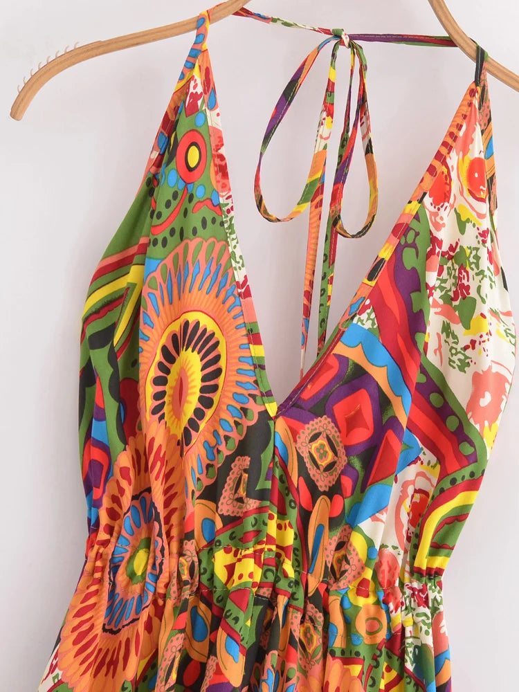 Colorful patterned dress hanging on a wooden hanger against a white background