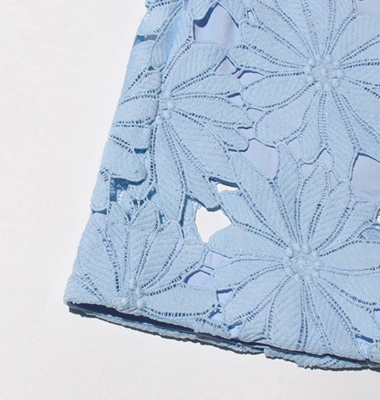 Close-up of a blue floral patterned fabric on a light gray background