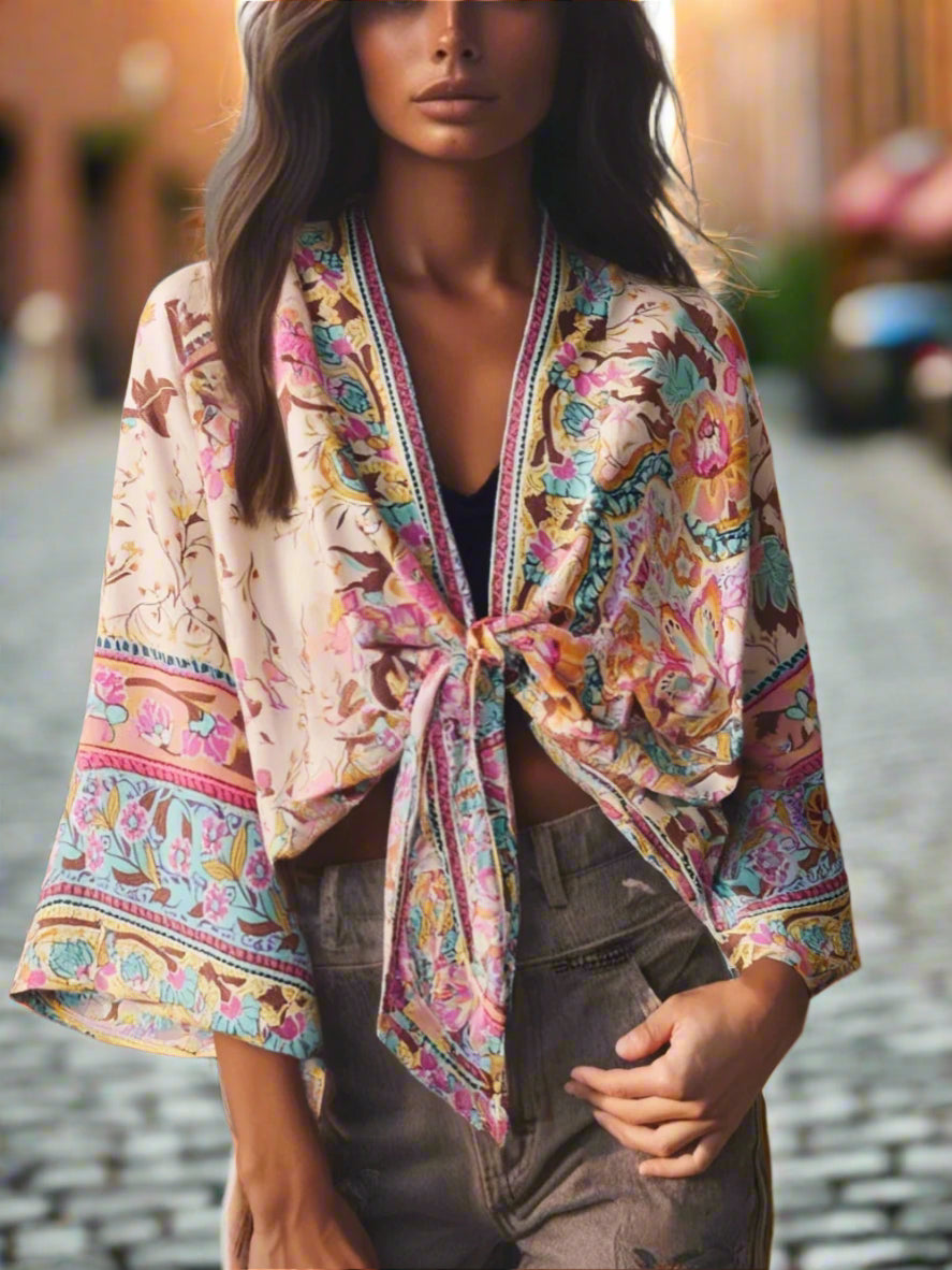 Woman wearing a colorful patterned jacket with a blurred natural background