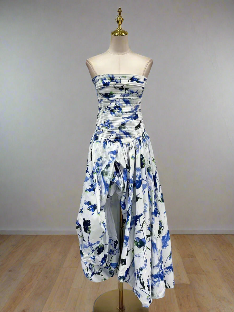 White dress with blue floral pattern on a mannequin against a white background
