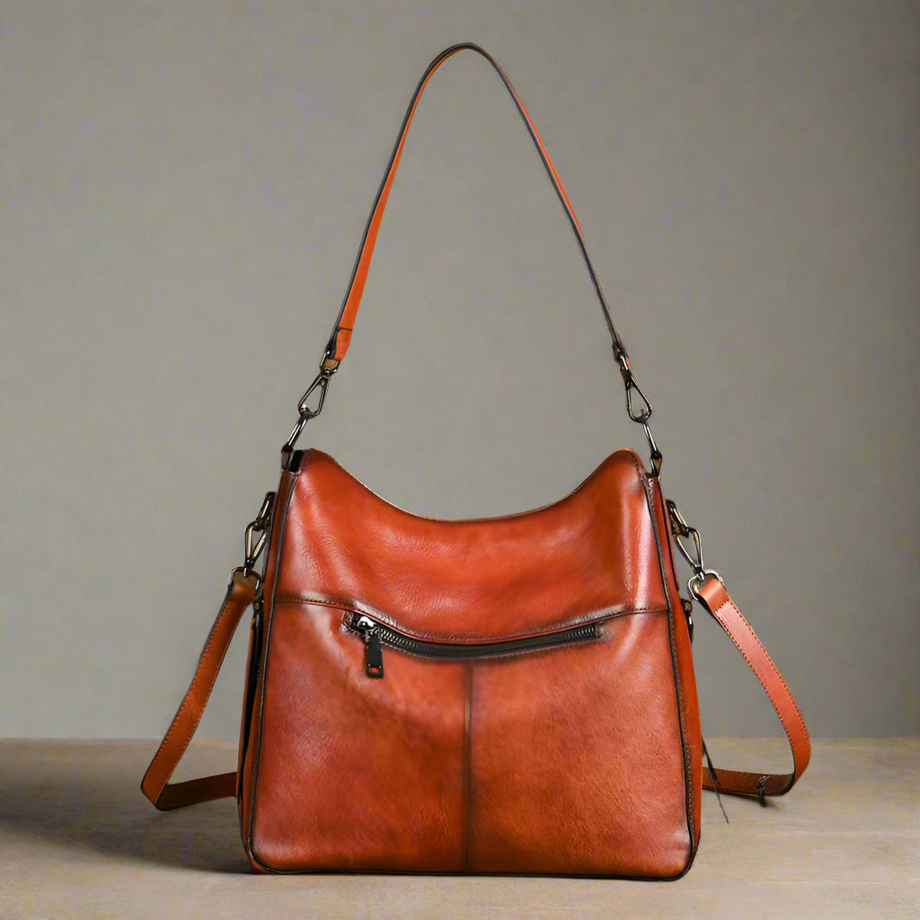Brown leather handbag with a light background