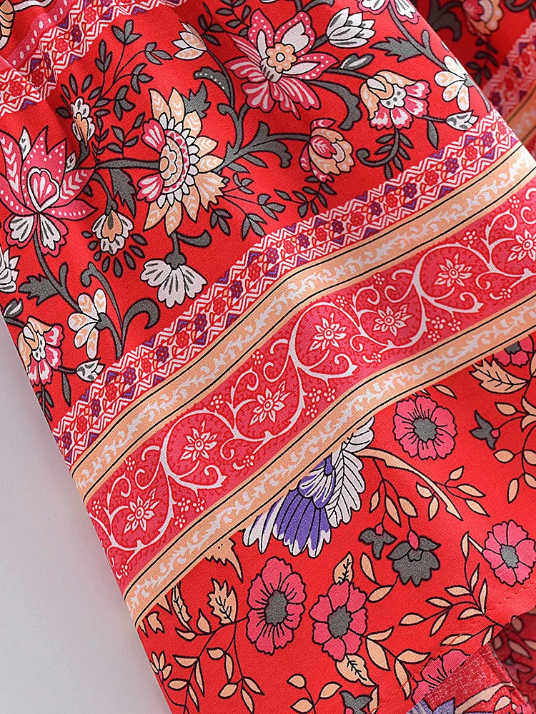 Close-up of a red fabric with floral and paisley patterns