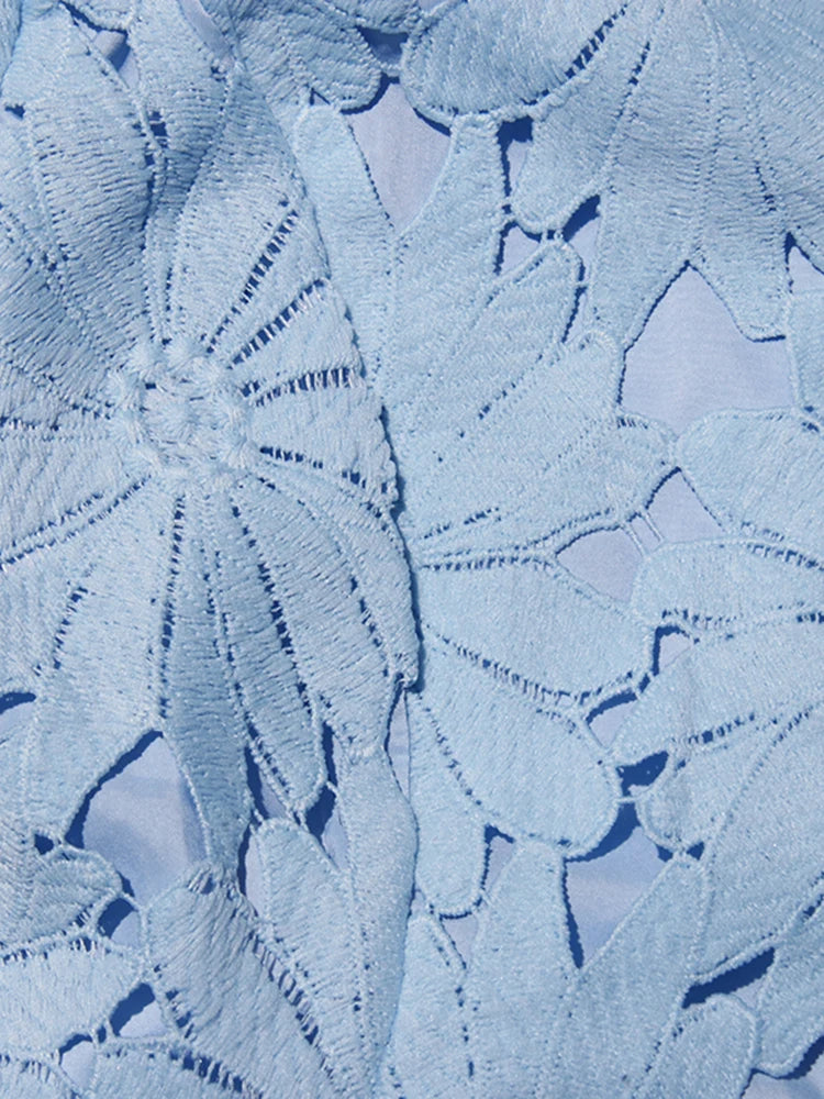 Close-up of textured blue fabric with a leaf pattern