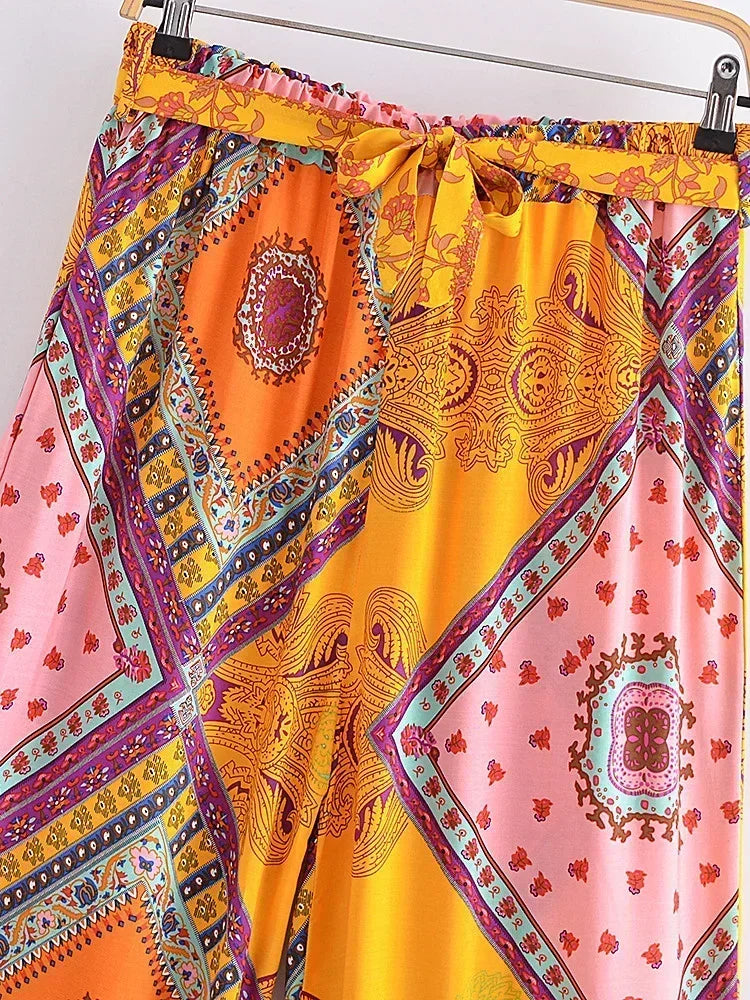 Colorful patterned fabric with a pink and yellow design on a hanger.