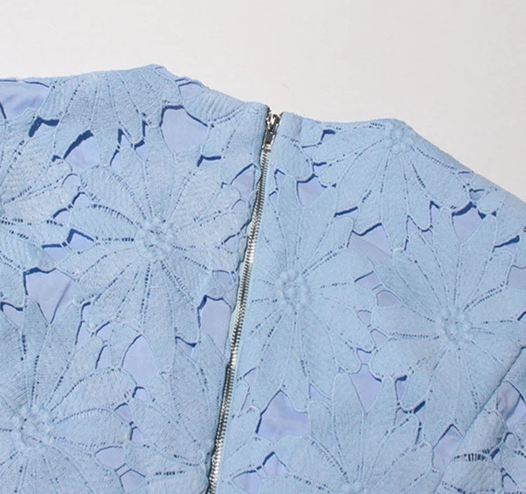 Light blue textured fabric with a zipper on a white background