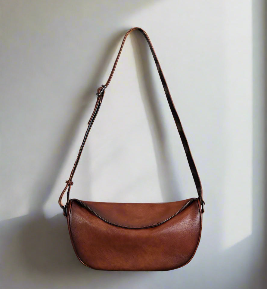 Brown leather bag with a white background