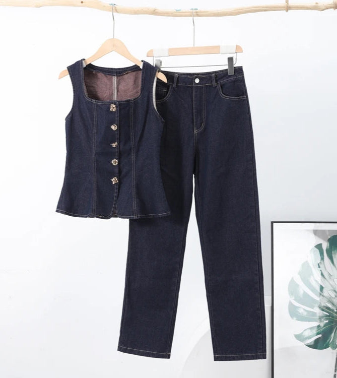 Dark blue denim vest and jeans on hangers against a white background