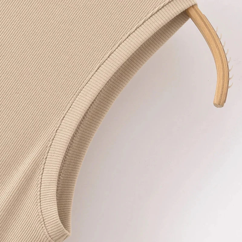 Beige dress on a wooden hanger against a light background