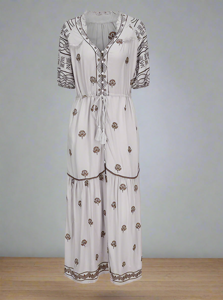 White dress with brown floral patterns on a white background