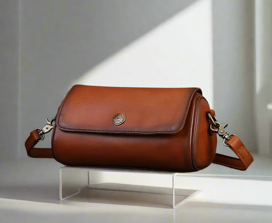 Brown leather bag with  on a white background
