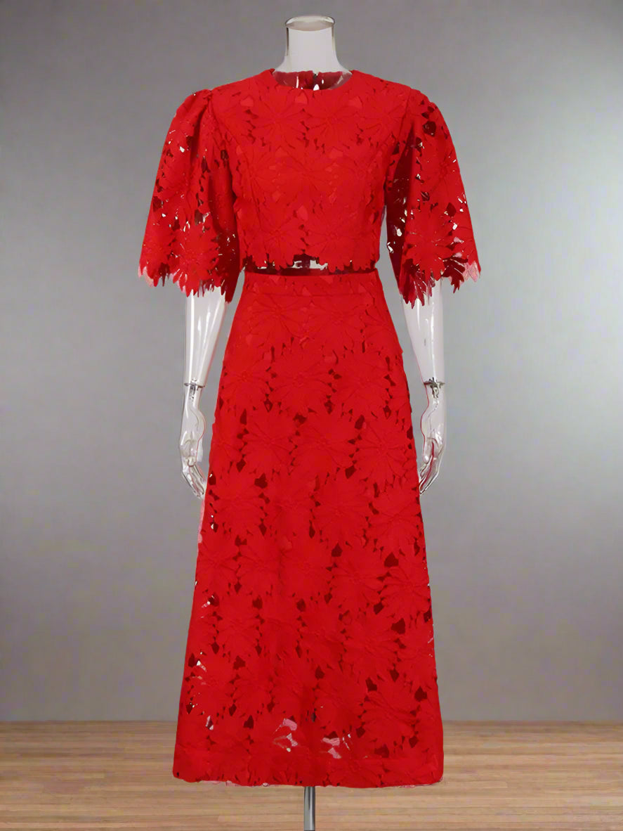 Red lace dress on a mannequin against a white background