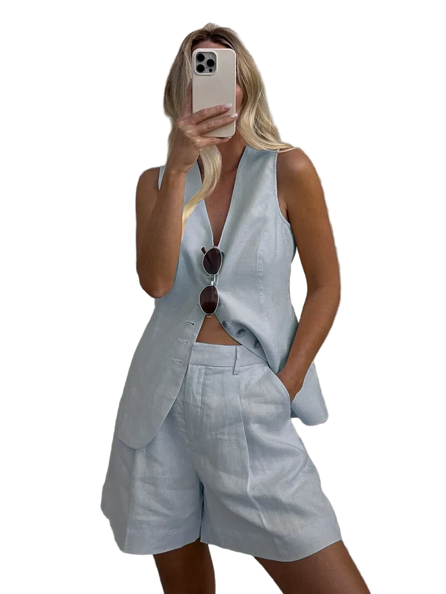 Person wearing a light blue outfit with a vest and shorts, taking a selfie.