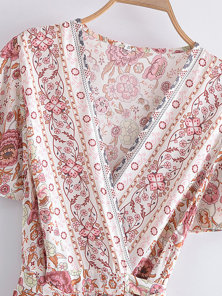 Floral patterned garment on a hanger against a white background