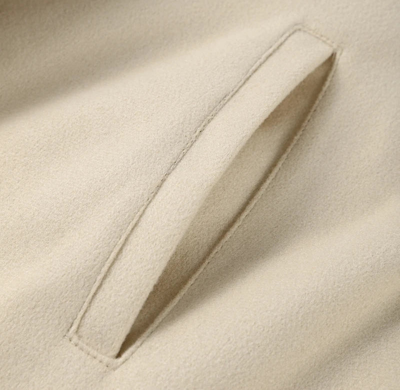 Close-up of beige fabric with a pocket detail
