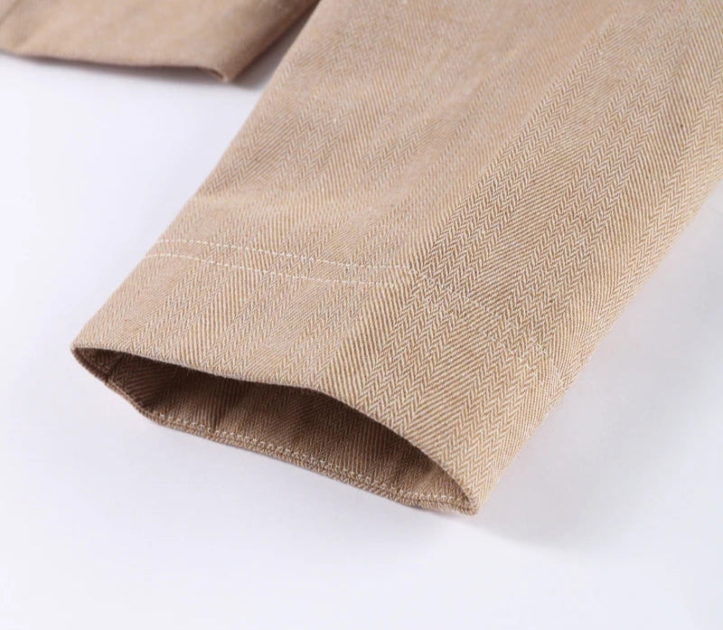 Close-up of beige fabric with a subtle pattern on a white background