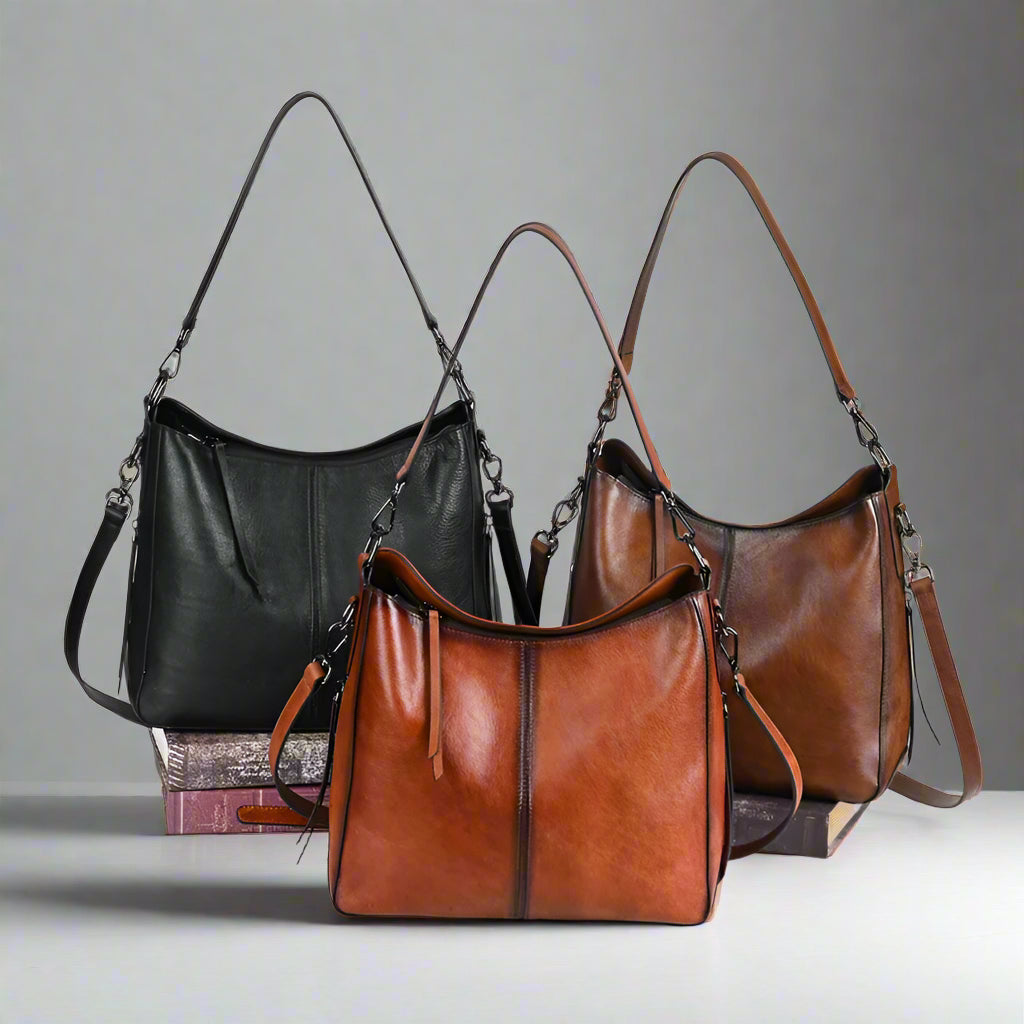 Three leather handbags in black, brown, and a mix of both on a white background.