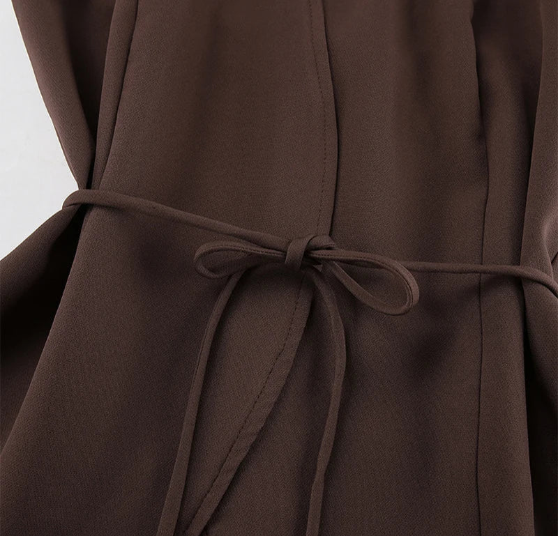 Brown coat with a tie detail on a white background