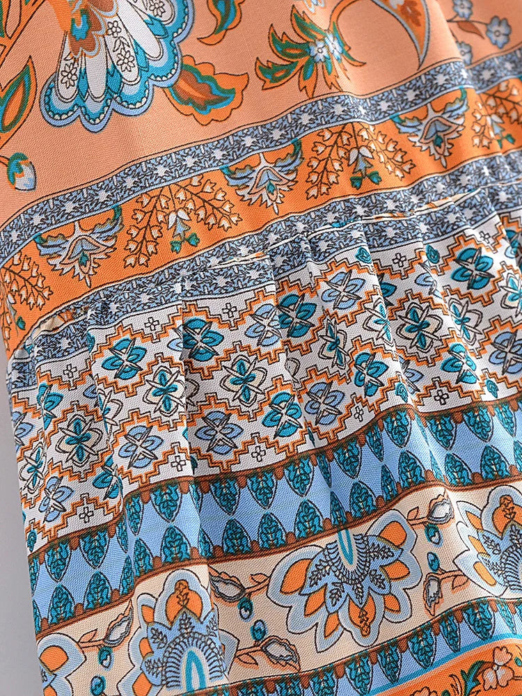 Close-up of a colorful patterned fabric with orange, blue, and white colors.