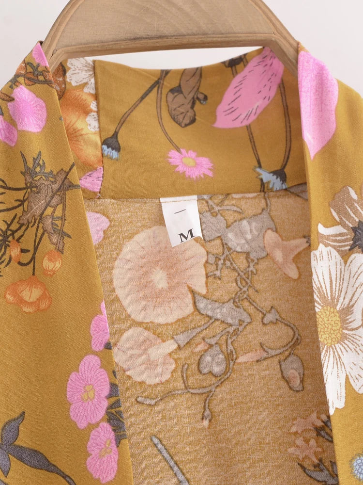 Floral patterned fabric with a tag on a wooden surface
