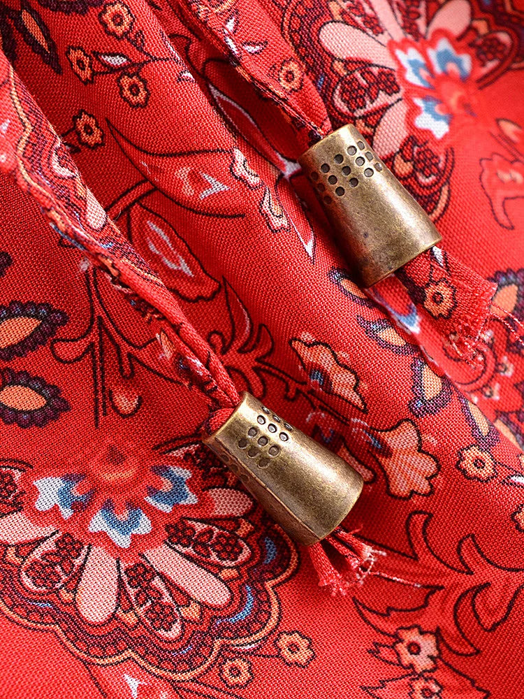 Close-up of a red patterned fabric with gold beads
