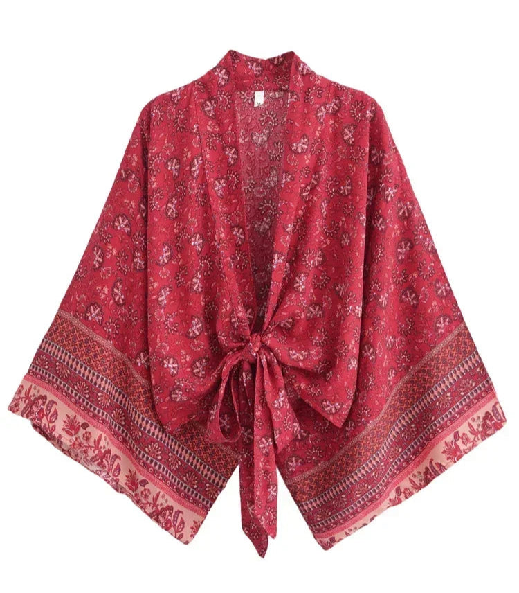 Red patterned shawl with a knot on a white background
