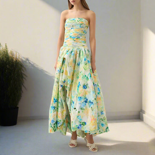 Woman wearing a floral strapless dress on a backyard garden