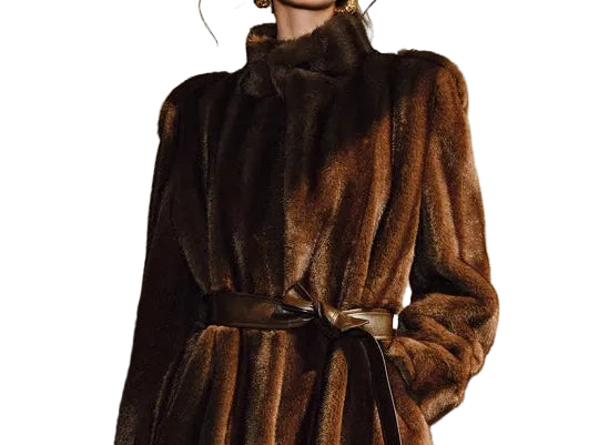 Woman wearing a long brown fur coat in an indoor setting