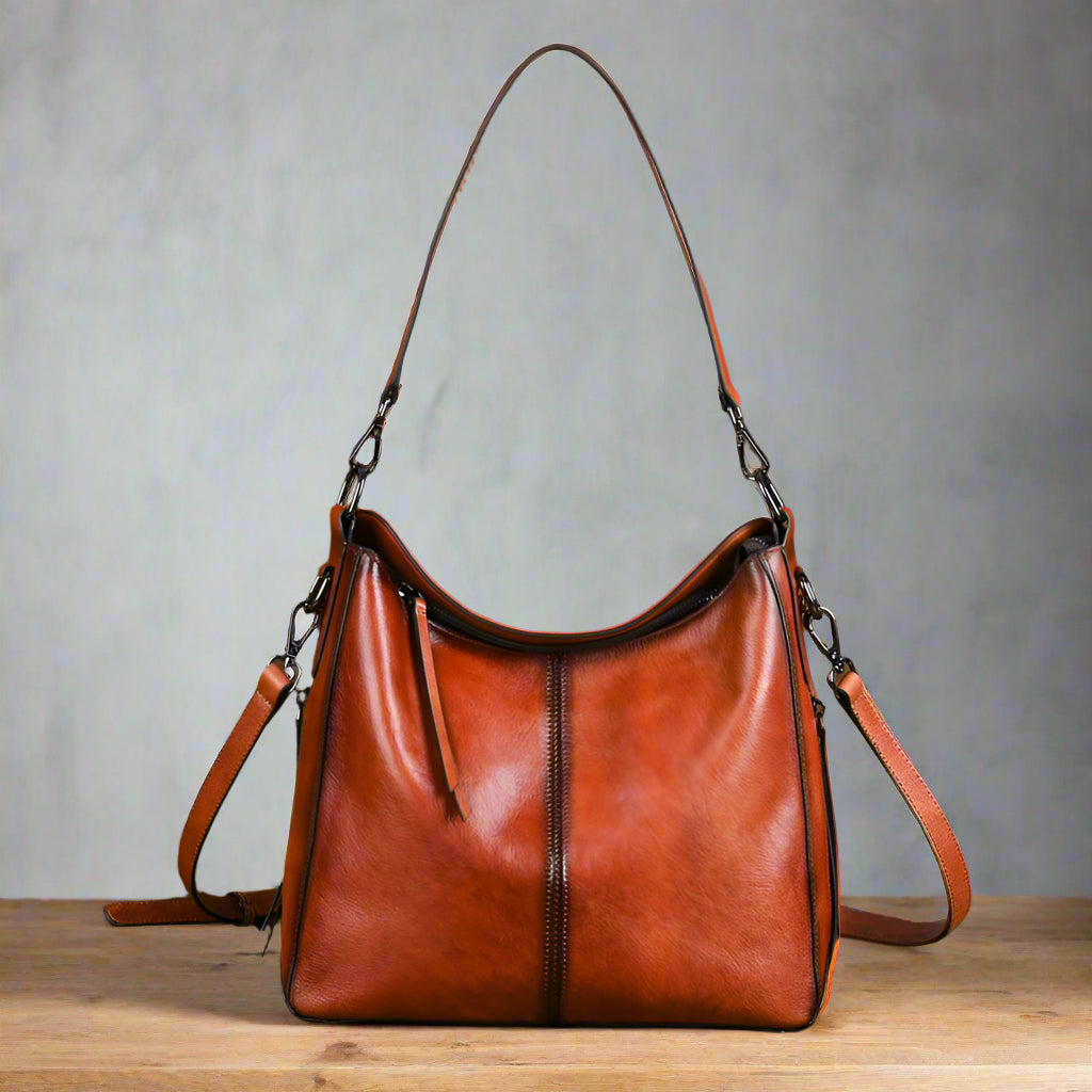 Brown leather handbag with a vintage suitcase on a white background