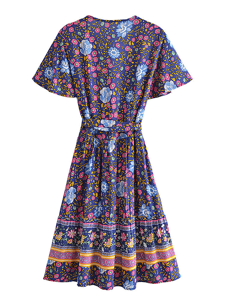 Colorful floral dress with a patterned hem on a white background