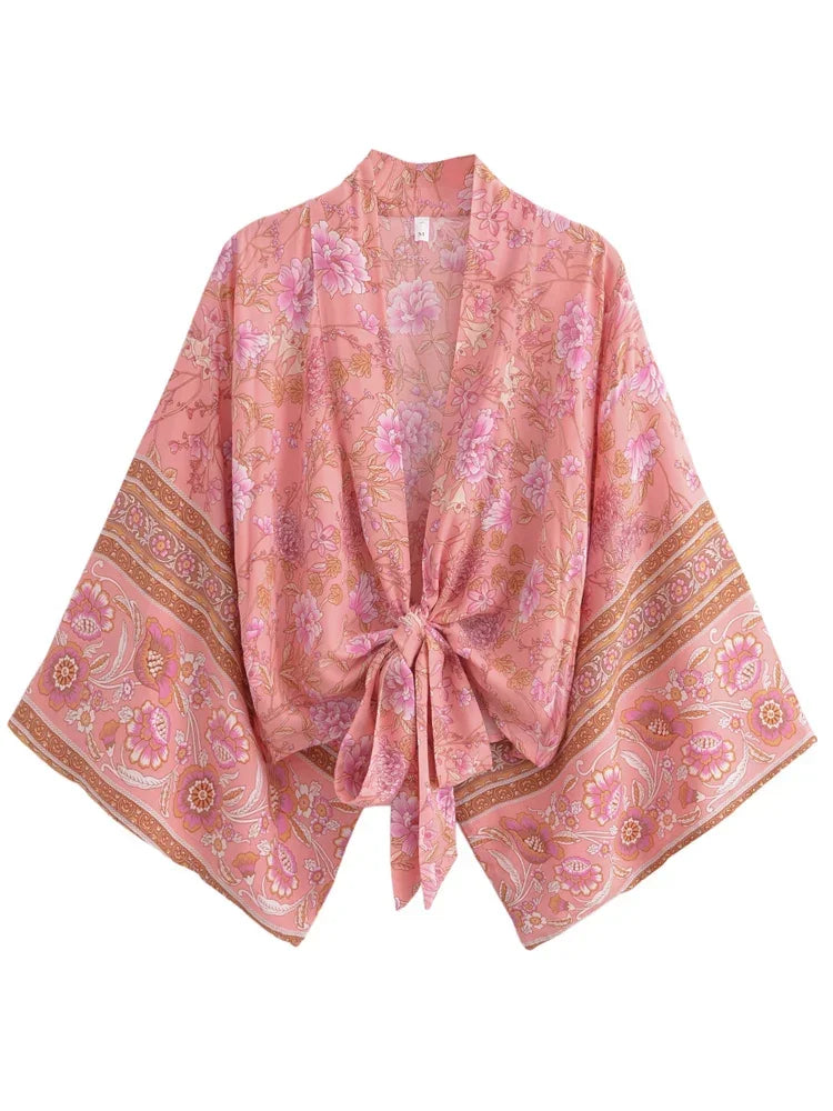 Pink floral patterned kimono-style garment on a white background