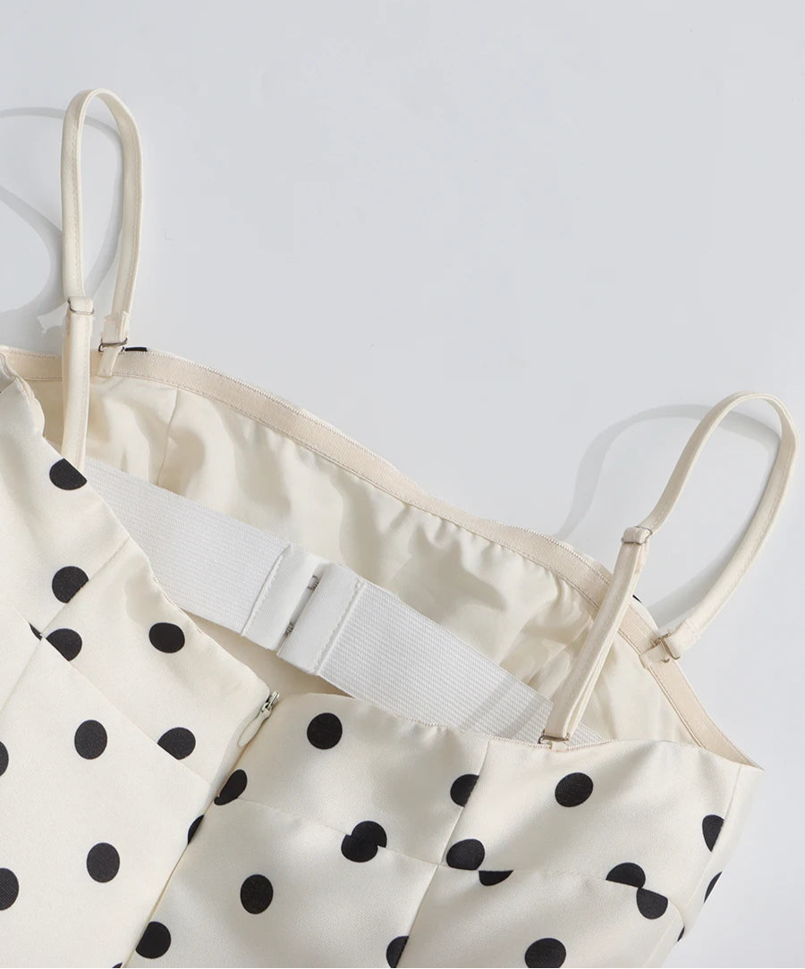 White polka dot dress with thin straps on a white background