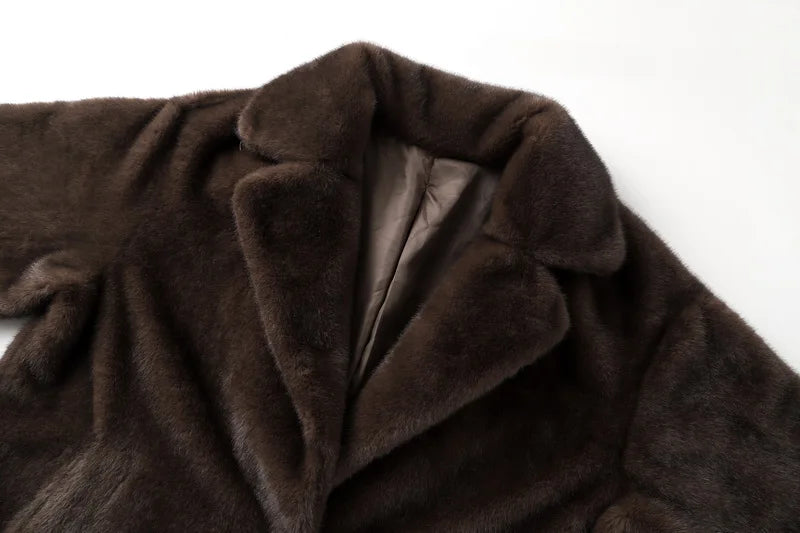 Close-up of a brown fur coat with a white background