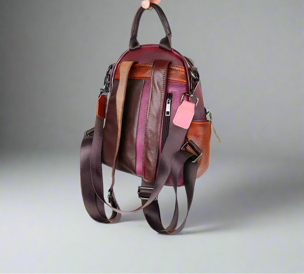 Multicolored backpack with visible zippers on a white background
